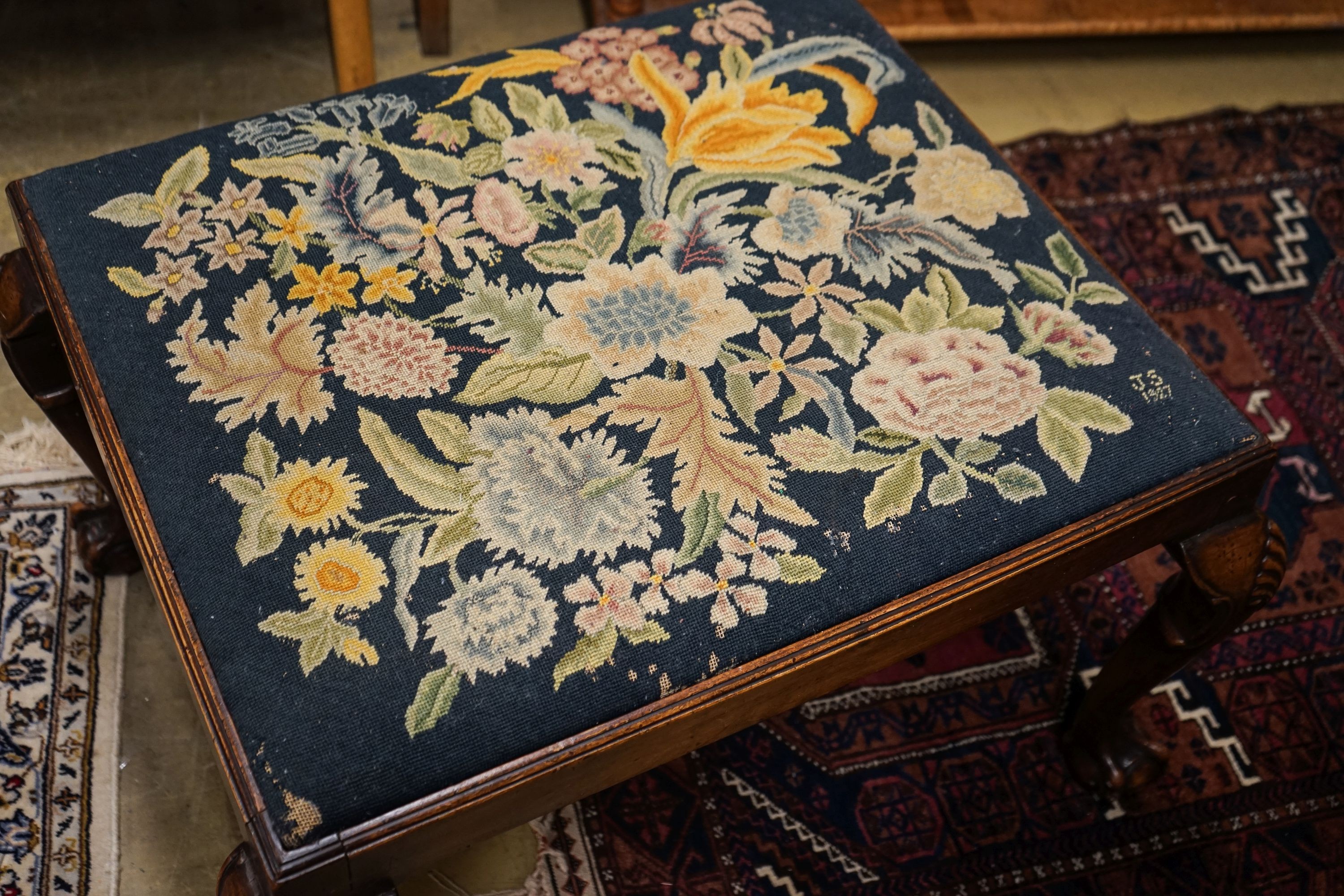 A George III style mahogany stool with drop in tapestry seat on ball and claw feet, signed JS 1927, length 76cm, depth 66cm, height 46cm
